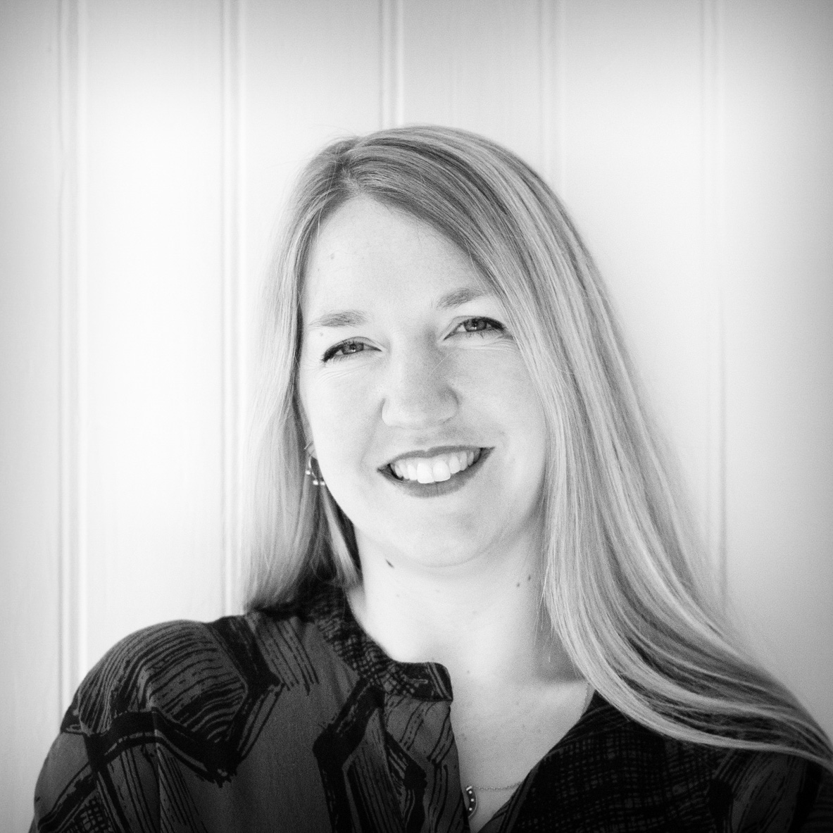 Photographic head and shoulders, black and white portrait of Carmel King.