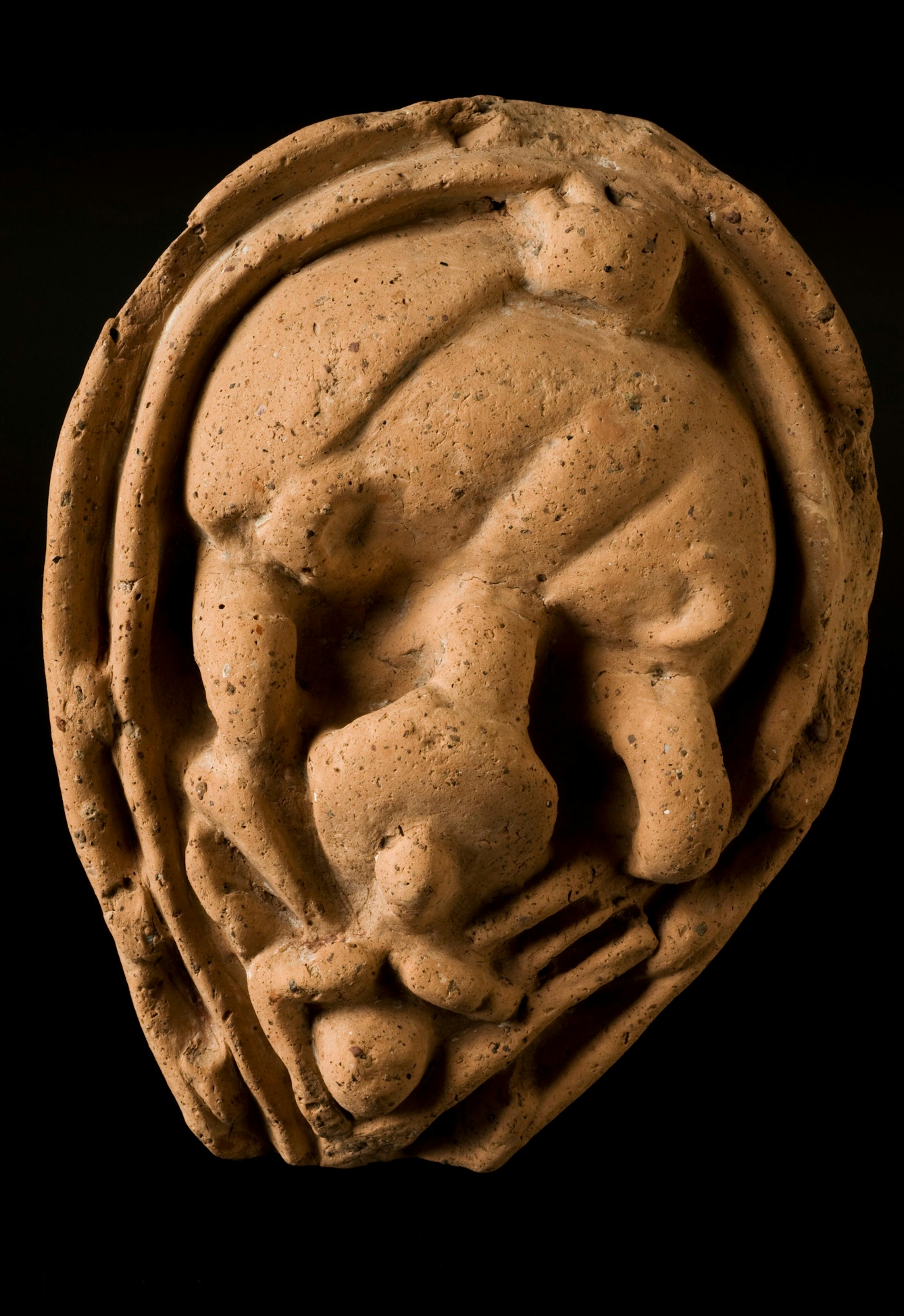 Photograph of a terracotta votive offering. The offering's shape is representative of intestines and abdominal organs. 