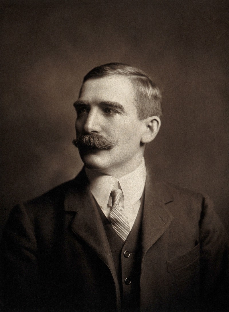 Black and white photo portrait of man with moustache and suit