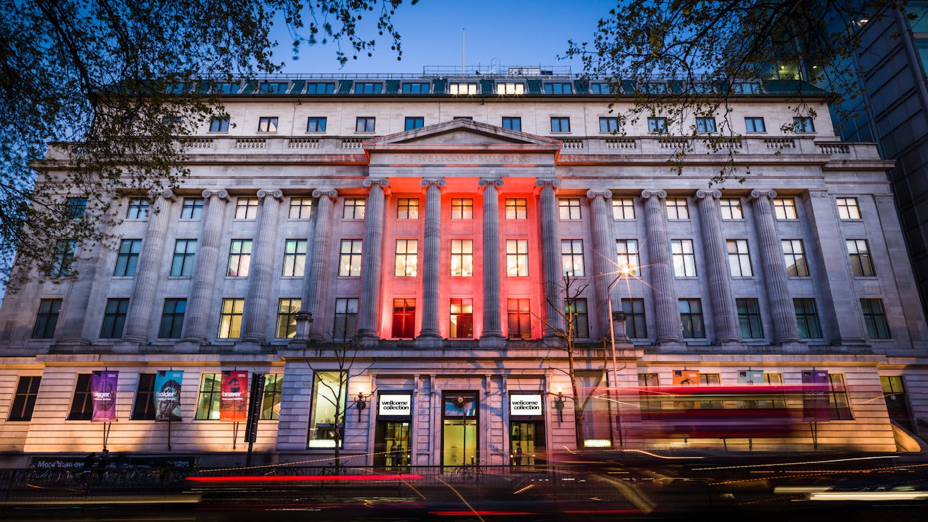 Photograph of the front elevation of the Wellcome Collection building at dusk.