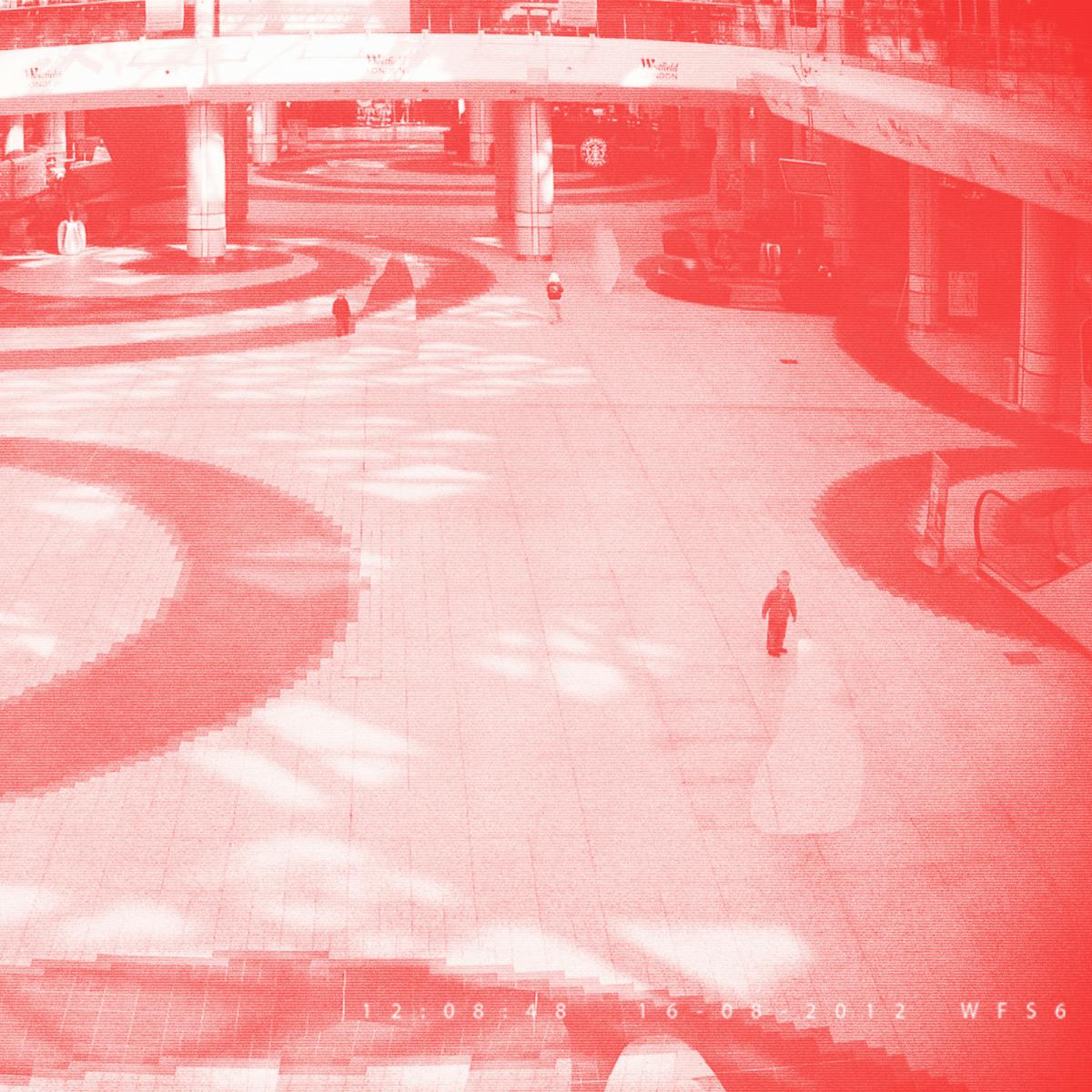 Pixellated photograph from a shopping mall security camera, where all adults have been crudely 'Photoshopped' out of the image, leaving one remaining child. The image has a red/pink tone applied to it.