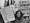 Black and white photograph of a protest with banners reading "COHSE help us to secure a better living wage for all ancillary workers" and "COHSE demand for the lifting of freeze on our members' pay rise"