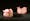 Two pairs of acrylic dentures with top and bottom teeth. Photographed on a black background.