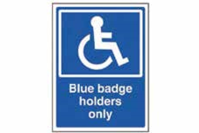 Standard rectangular Blue Badge for people with mobility issues. The text “Blue badge holders only” is written below the image of a figure in a wheelchair. 