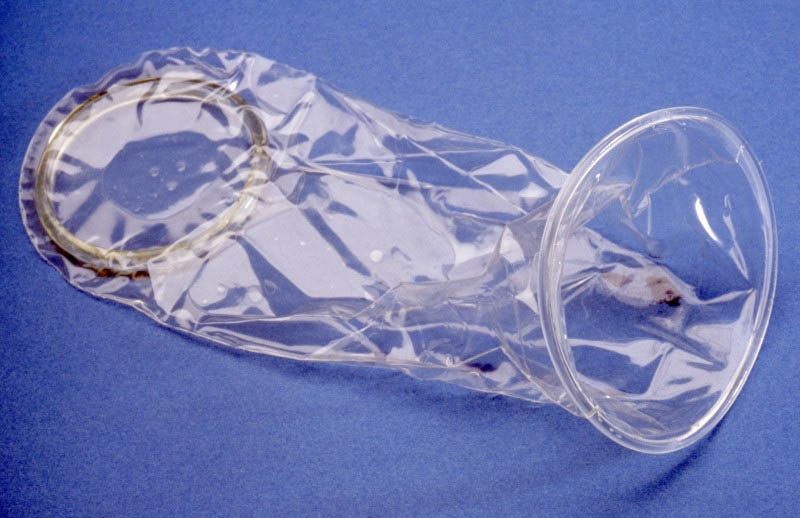 Photo of a clear plastic female condom on a blue background