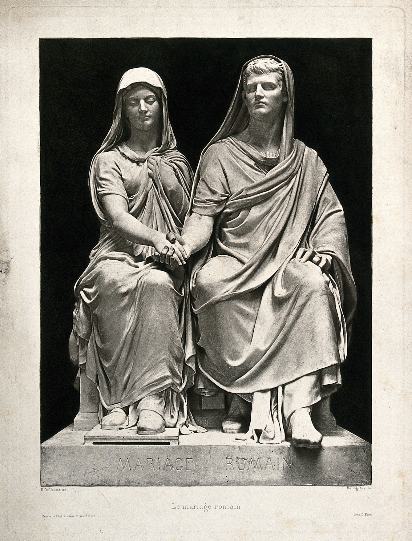 Black and white photograph of a seated couple in Roman dress, holding hands.