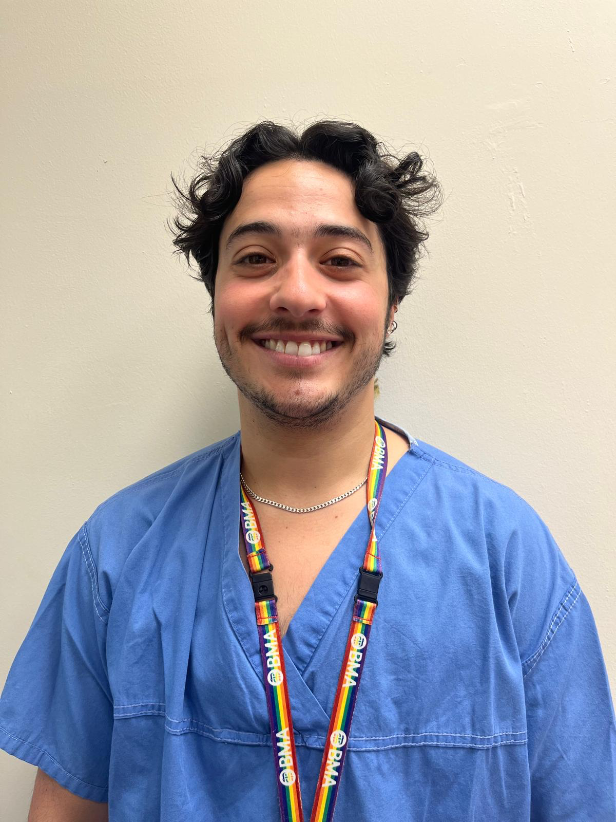 Photo of Dr. Ravi in blue scrubs