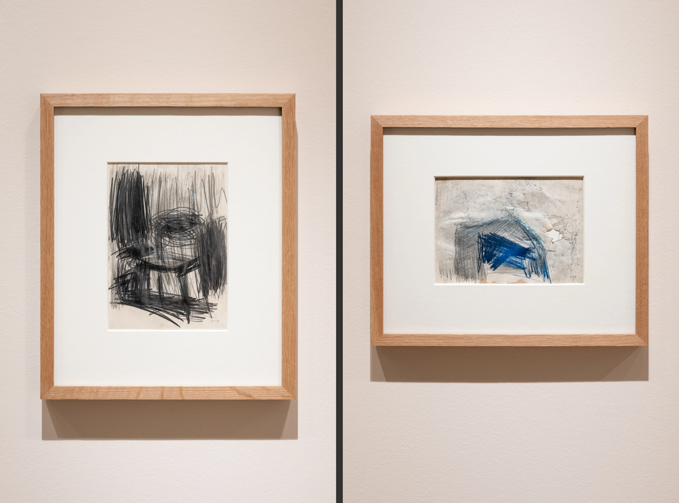 Photographic diptych showing two framed artworks. On the left the artwork shows an abstract chair drawn in charcoal, on the right the marks of the drawing have torn through the paper.