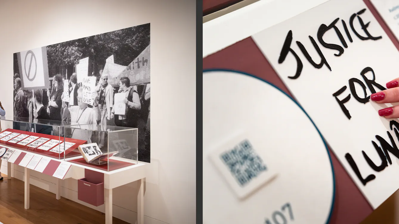 Photographic diptych. The image on the left shows two gallery visitors standing at a display case, looking at a large black and white halftone photograph on the wall of a protest march. The image on the right shows a close up of a hand touching a tactile display panel which shows the words 'Justice for Lunatics' in 3D raised typographics.