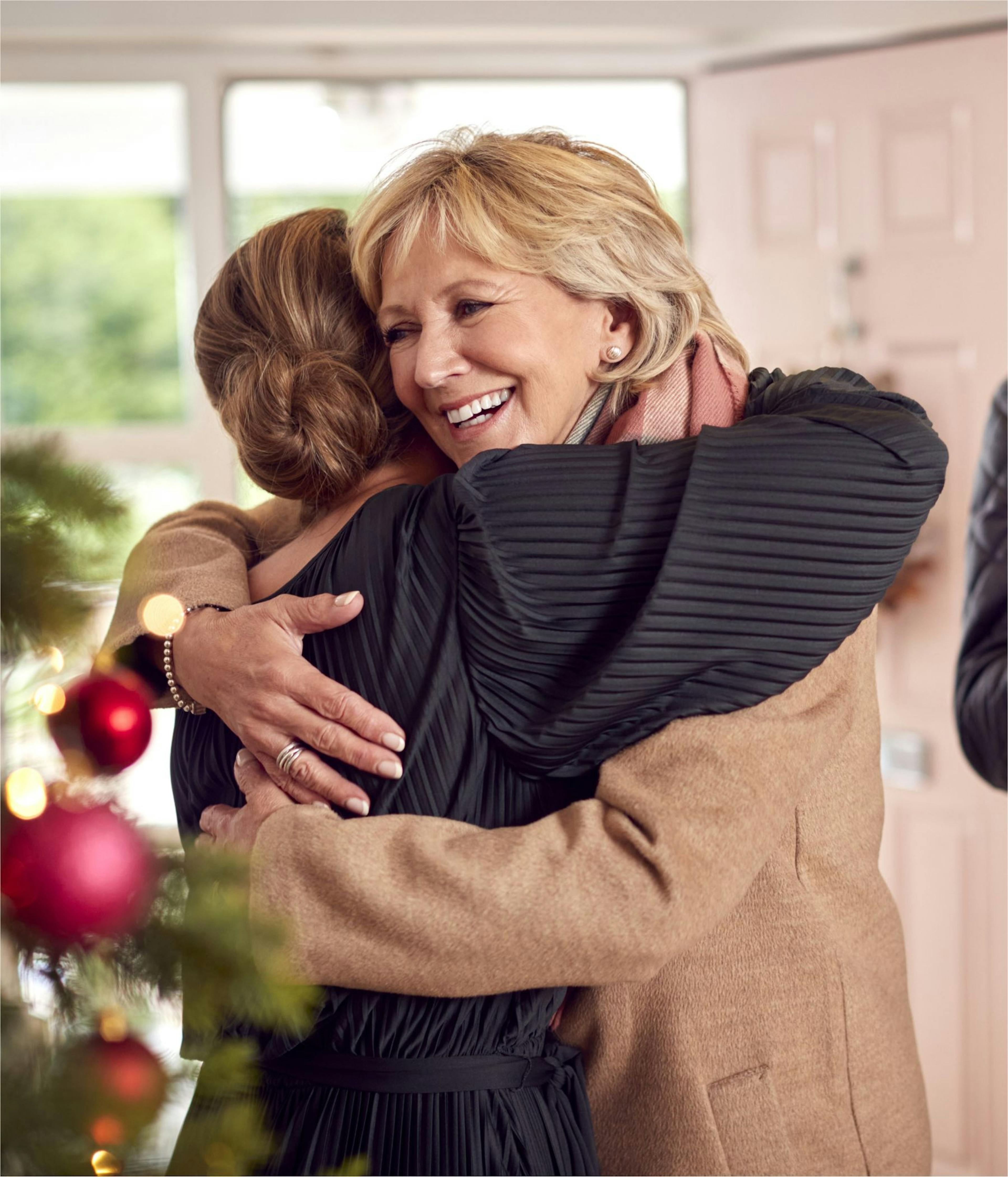 Two women hugging at Christmas