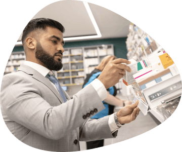 Pharmacist taking medication off shelf