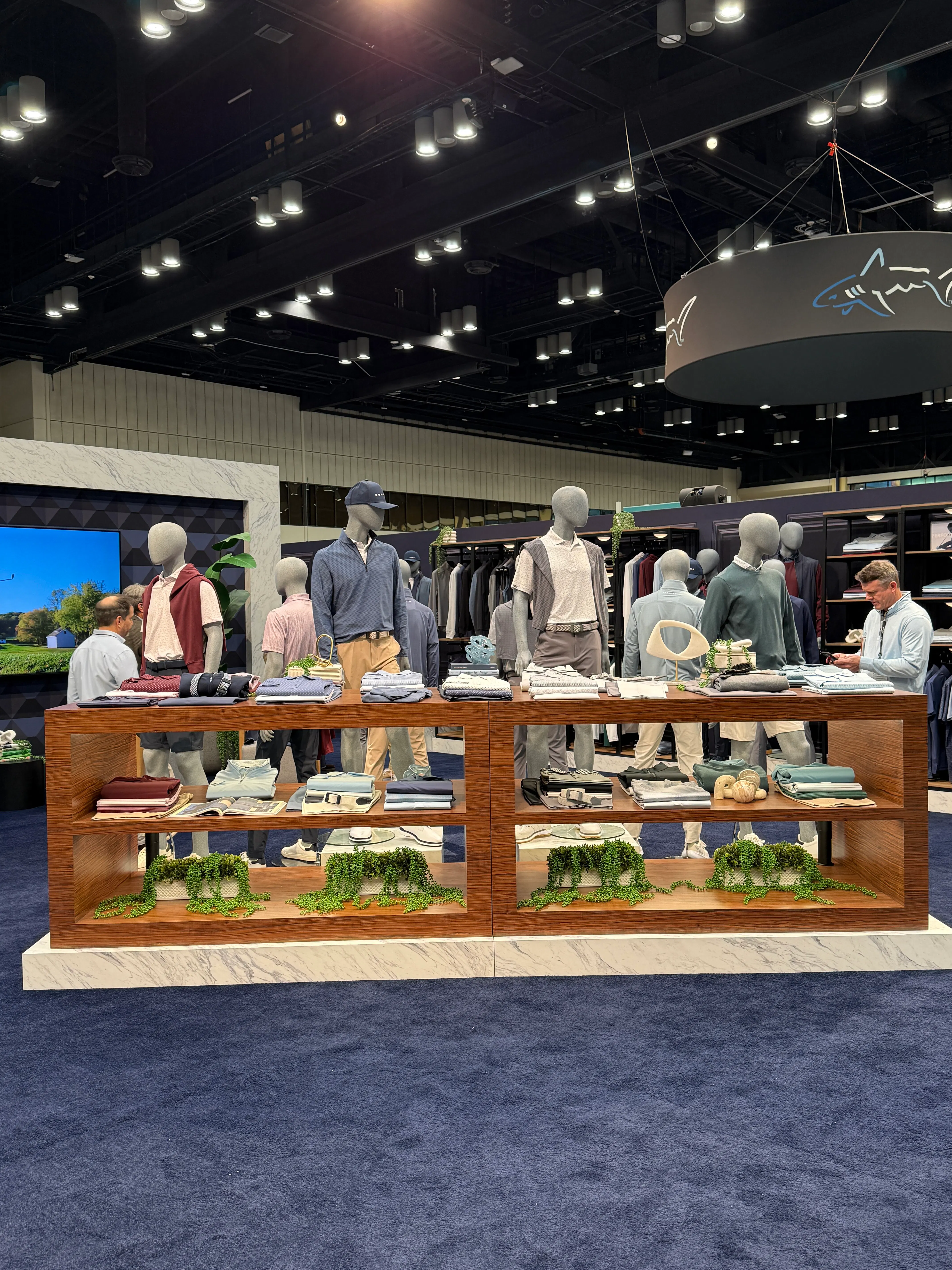 Tradeshow display of the Dunning booth with people in the background