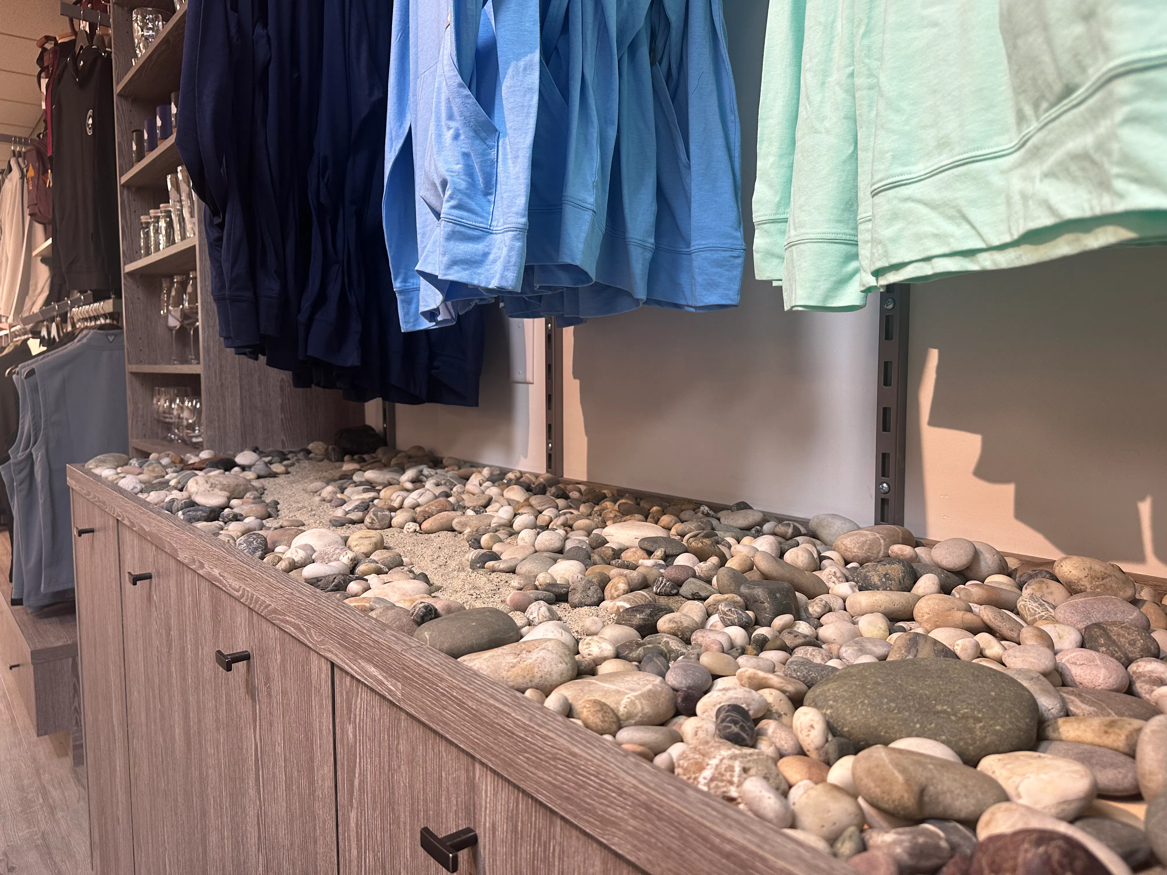 Riverstone display with merchandise hanging above