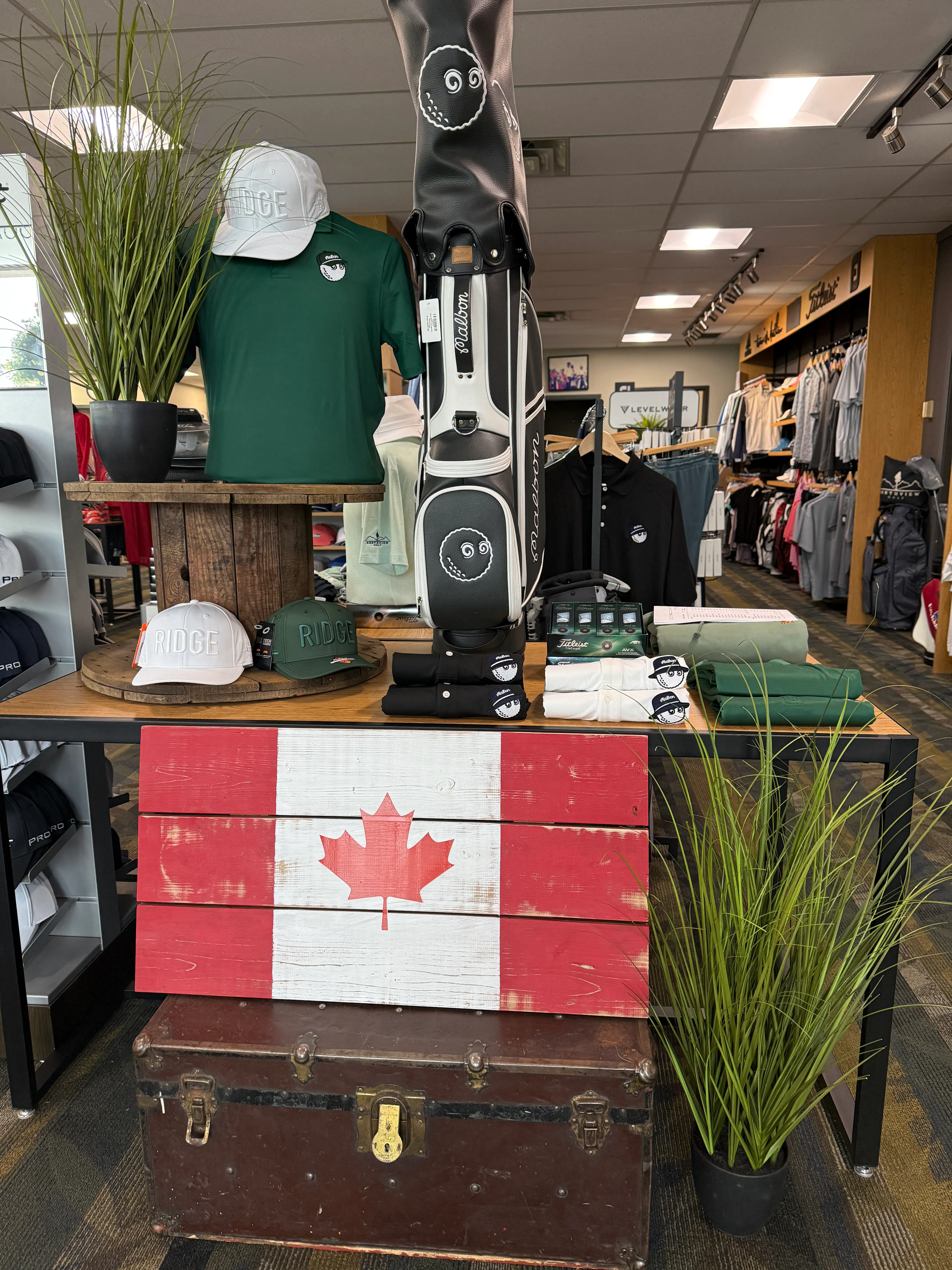 Northview pro shop apparel and accessory display with Canadian flag in foreground