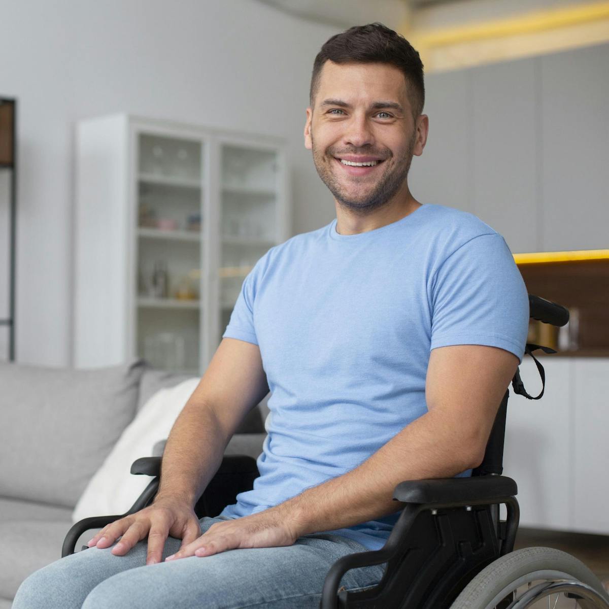 Patient mit Multipler Sklerose im Rollstuhl lächelt in die Kamera