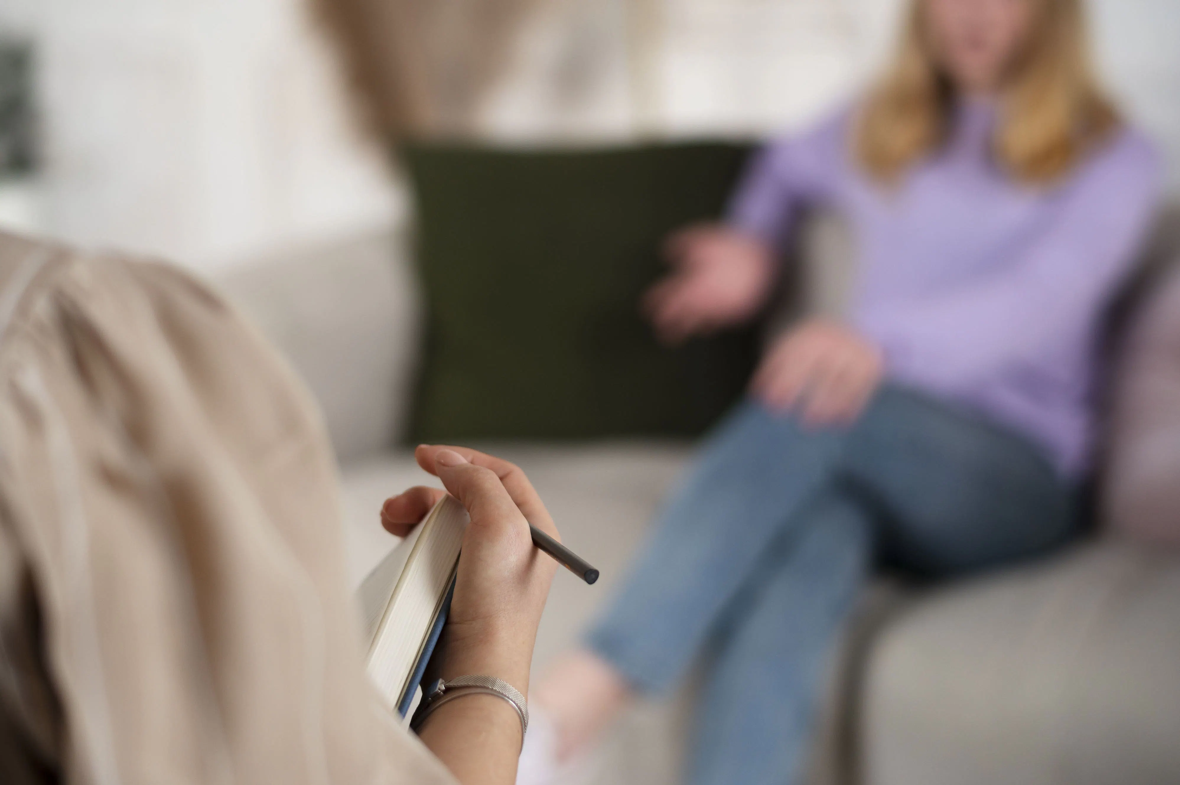 Patientin und Psychologin sitzen sich in einer Gesprächssituation gegenüber