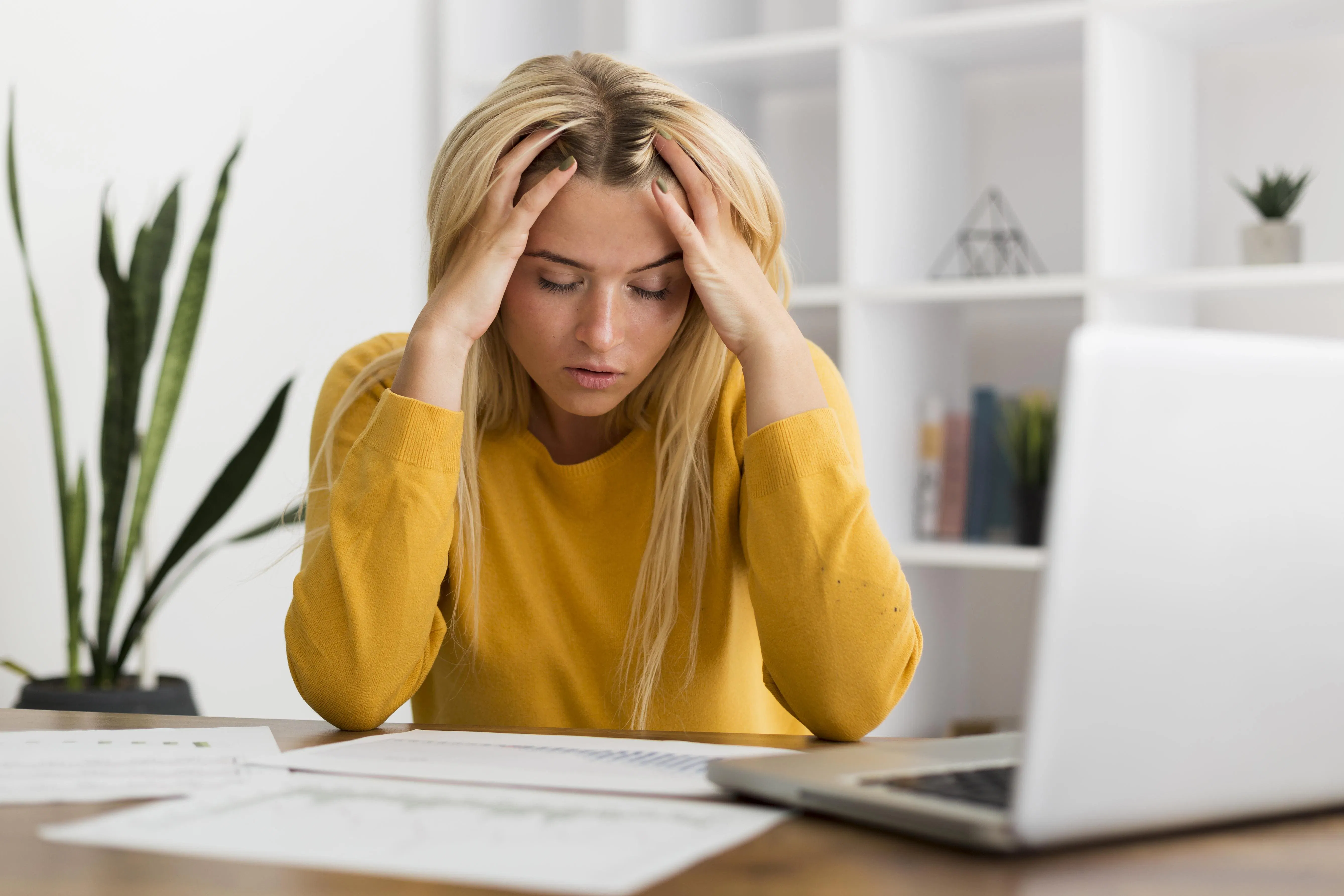 Frau sitzt verzweifelt vor ihrem Laptop