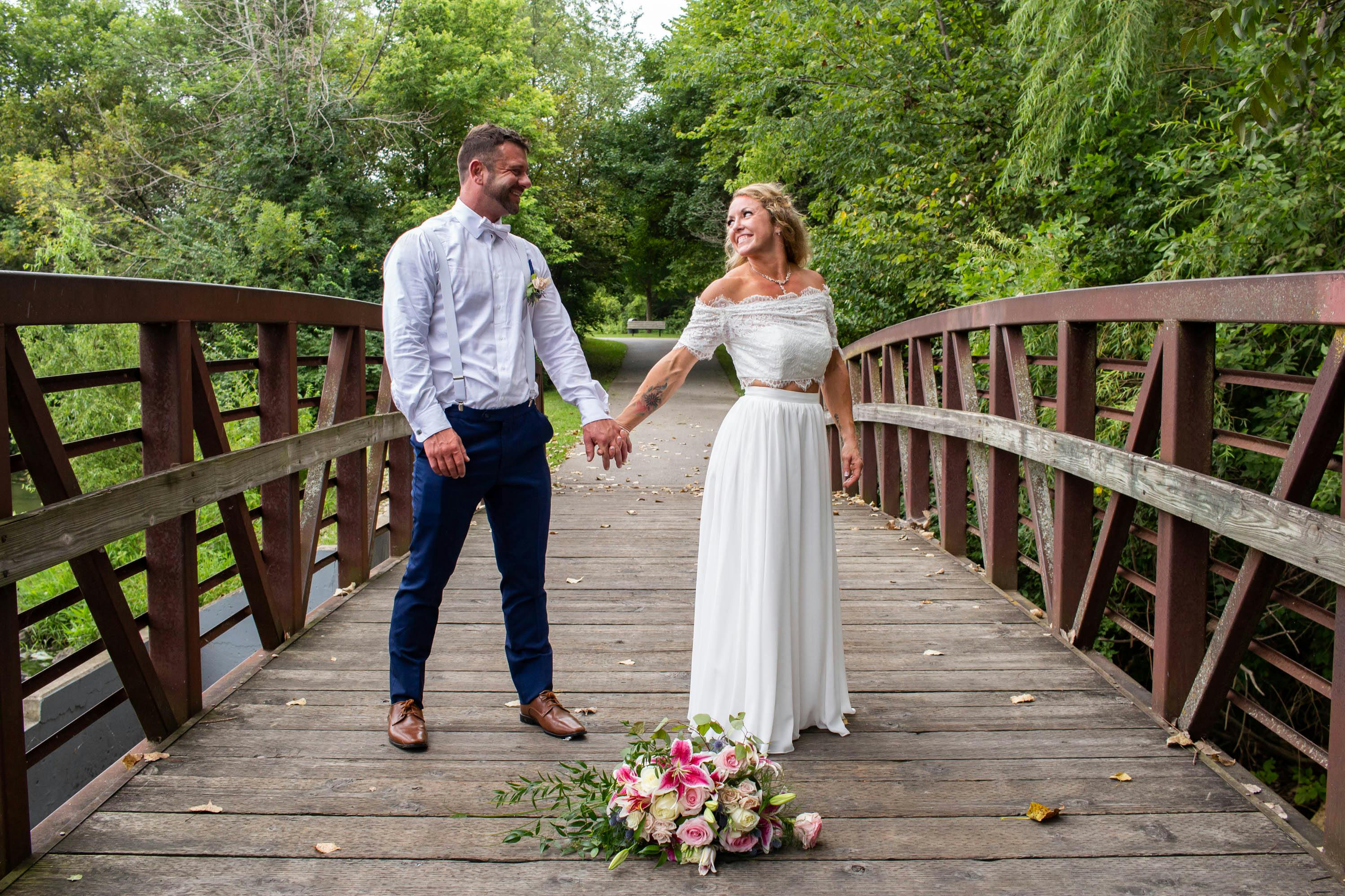 Couple holding hands on a bridge