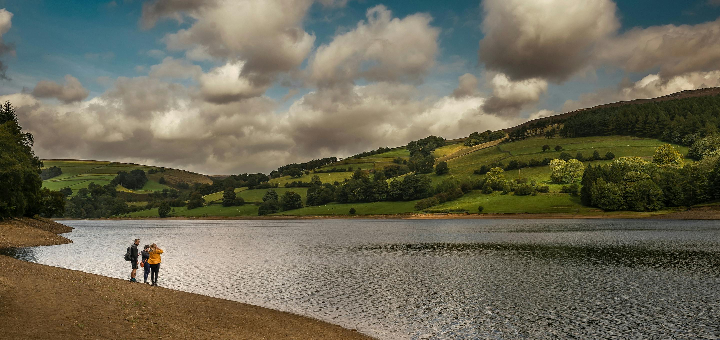 lake and hills over landscape with people