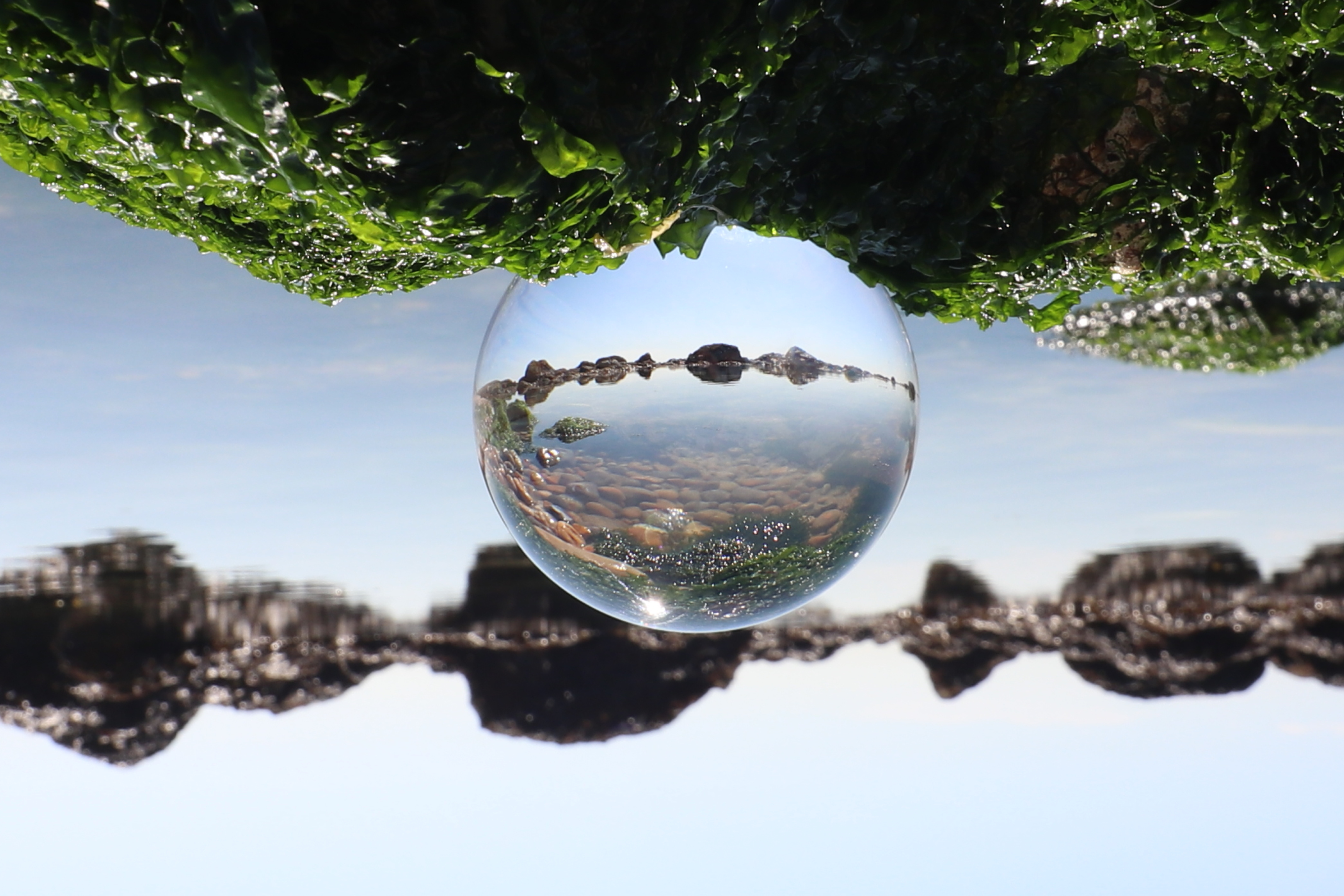 A water droplet showing a rocky landscape
