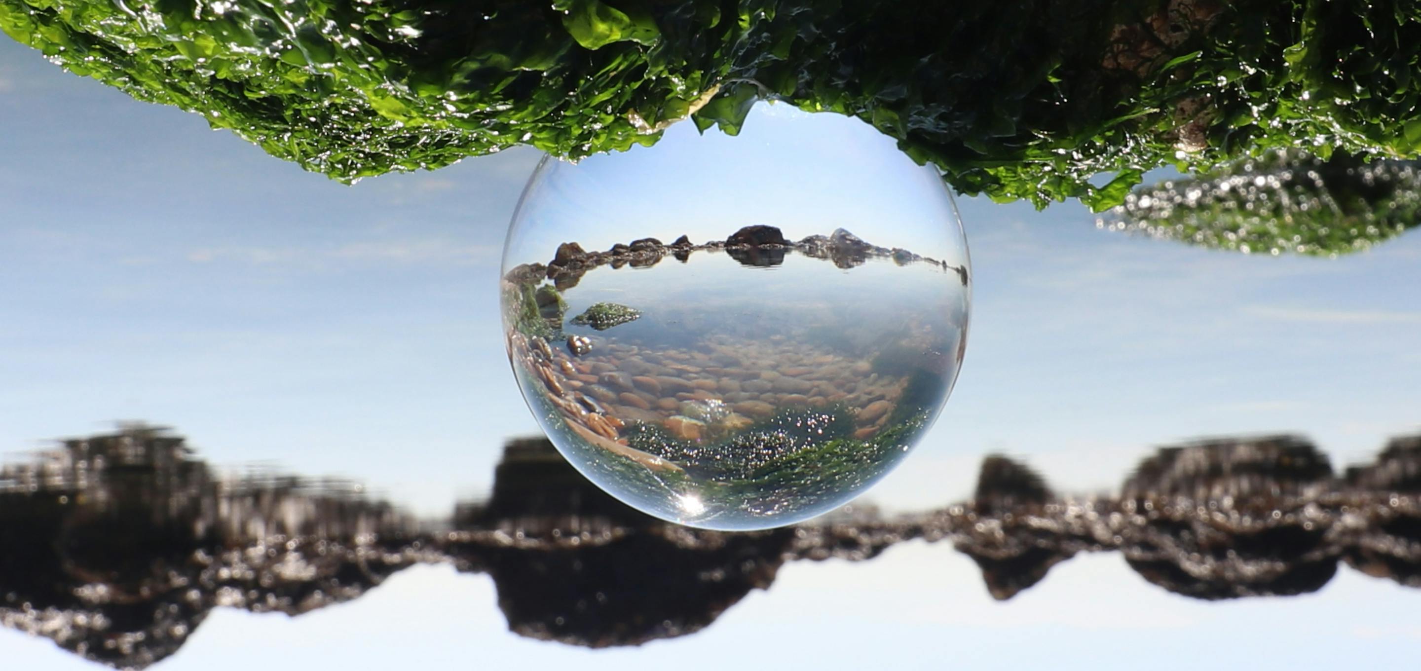 A water droplet showing a rocky landscape