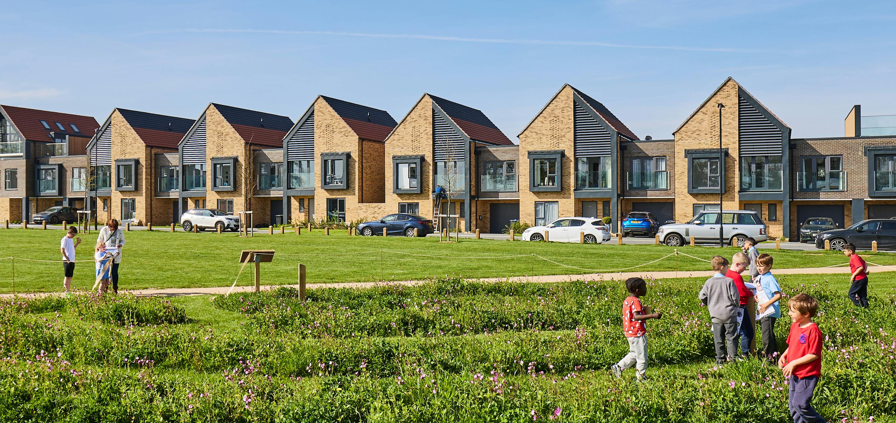 Children playing outside a row of houses