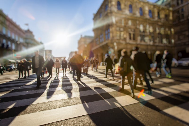 Crowd of people walking on busy city street