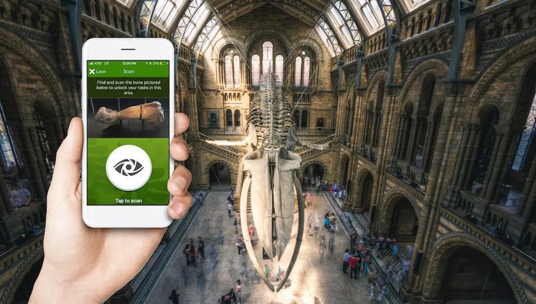 Inside the natural history museum, london. Using an app.