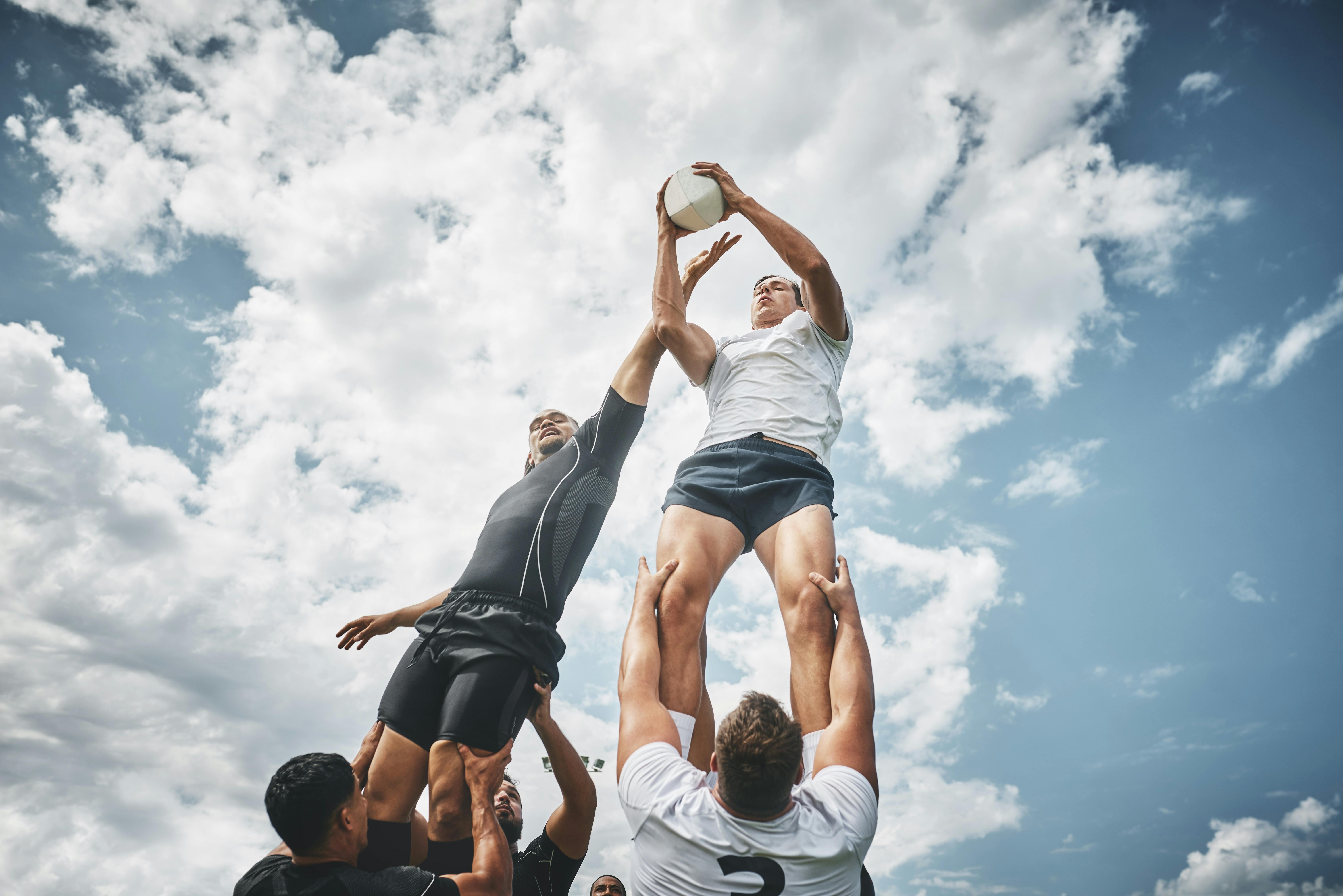team holding rugby ball
