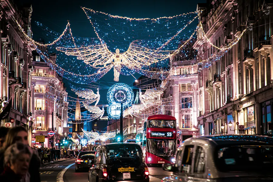 A photo of Regent Street in London decorated for Christmas featuring a red double decker bus.