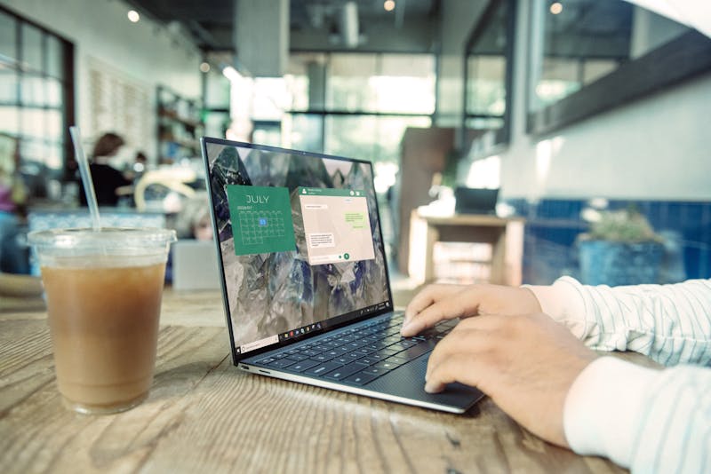 man working on laptop in a cafe