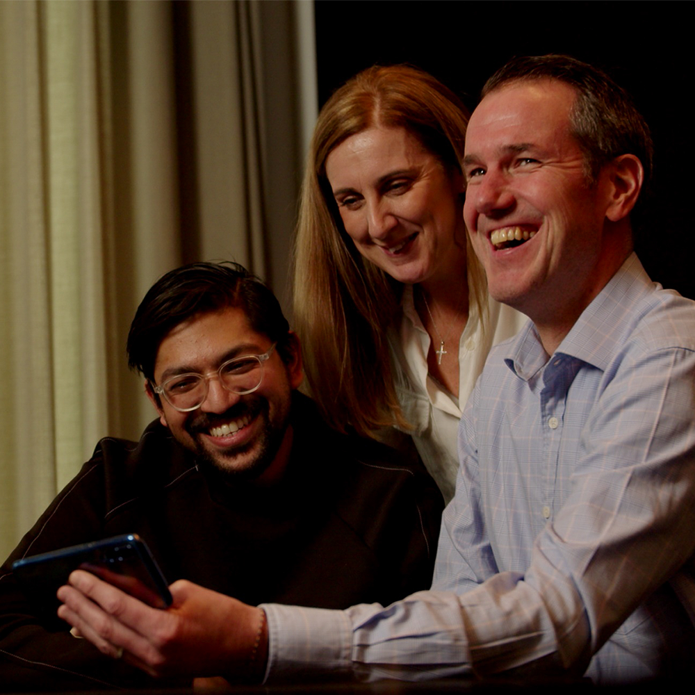 A happy trio of people using the Wildgoose App