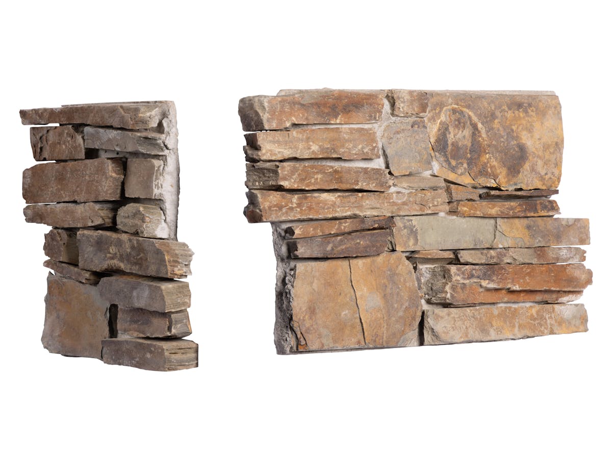 The small and medium flat panels of real split-faced stone as used to construct cladding for an exterior corner