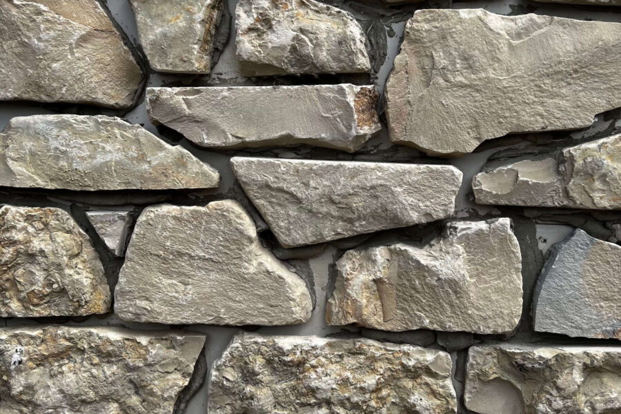 White Lias Limestone. It has a colouring of light to darker cream, with occasional crystal white seams.