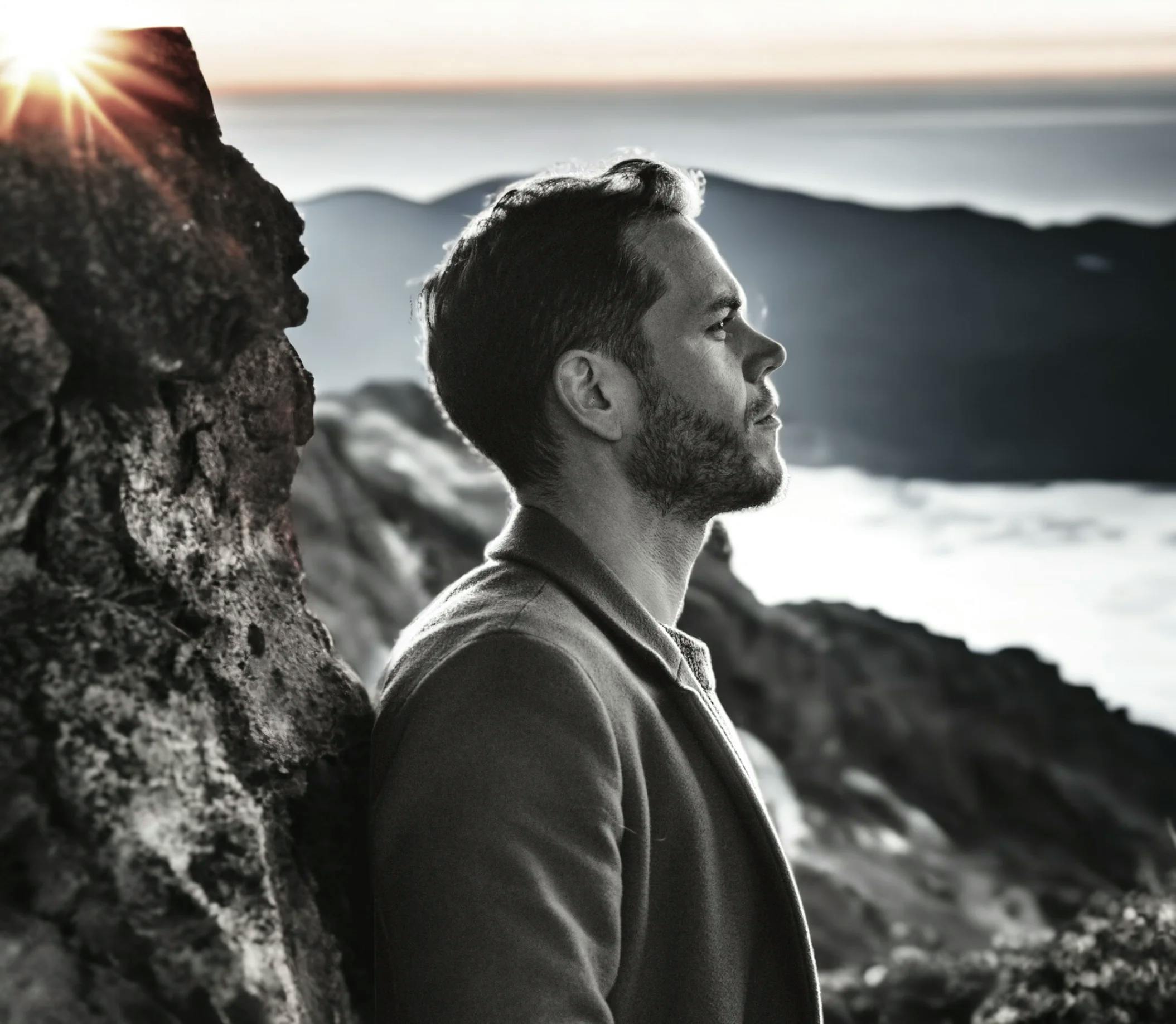 William Baker with rocks and sunset in the background