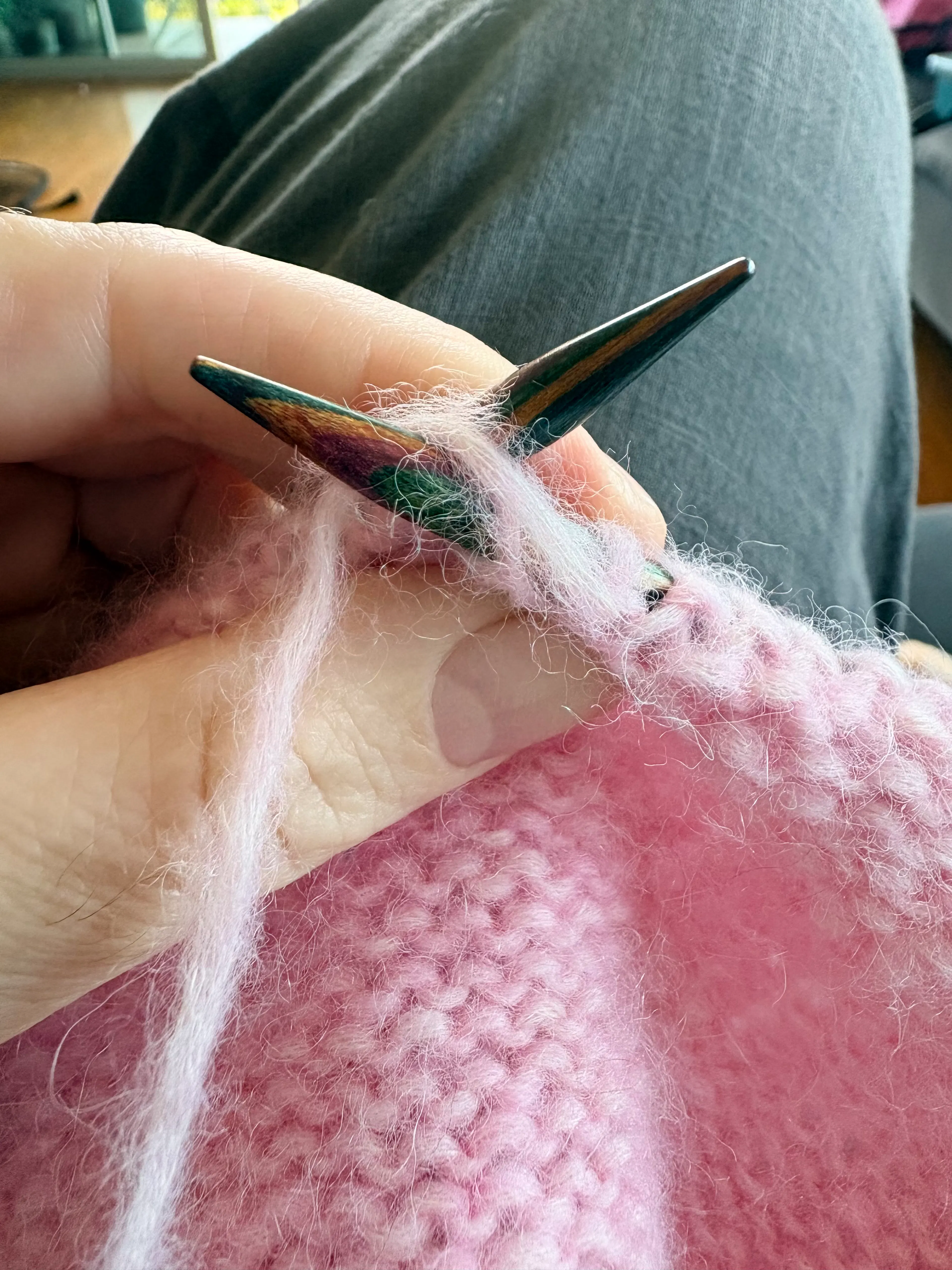 Knitting needles knitting a pink item