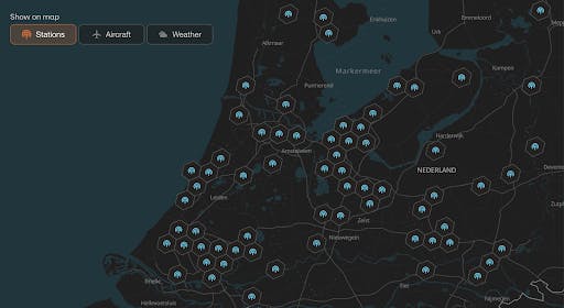 Wingbits map interface showing ADS-B hardware stations, flights, and weather in dark mode. 