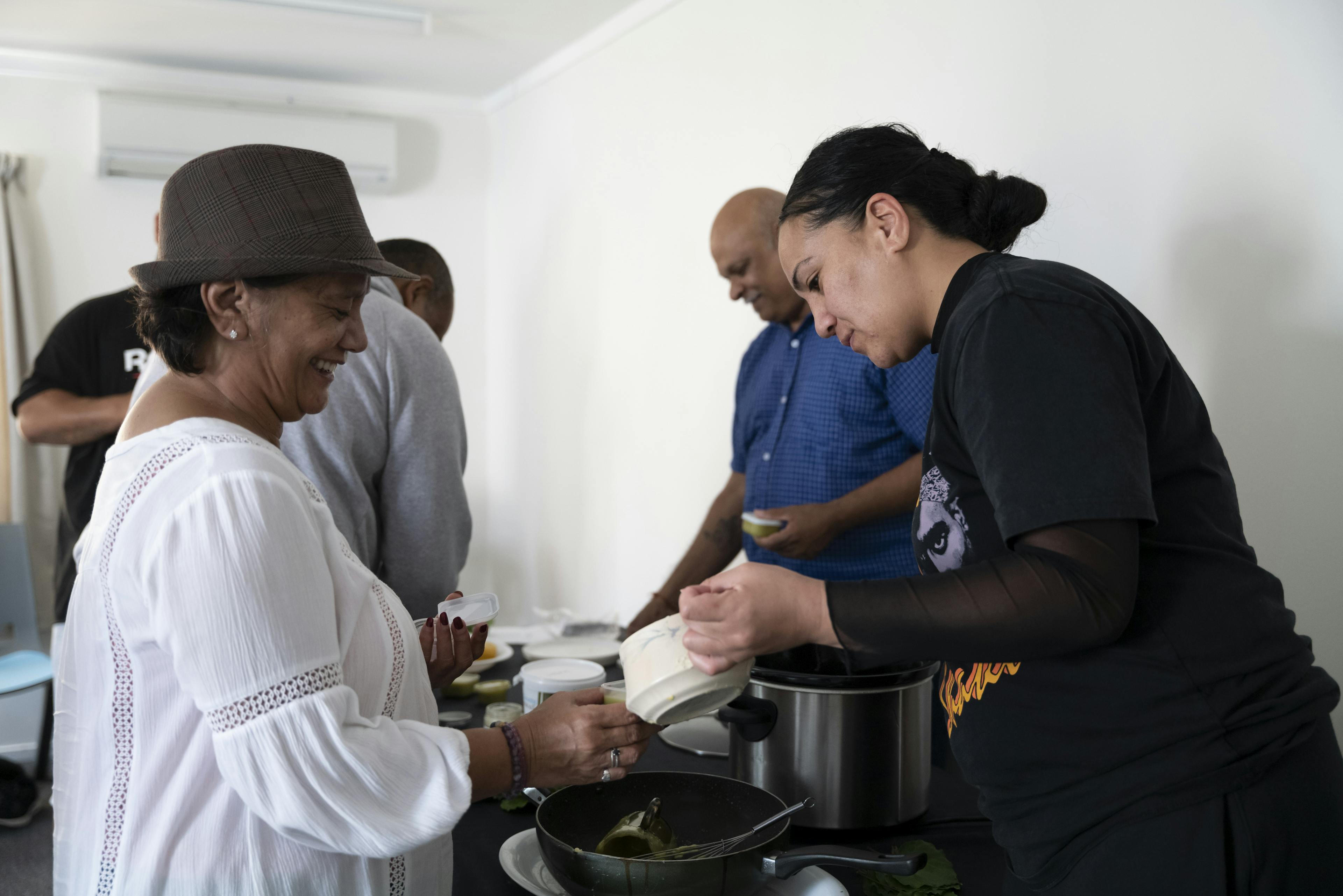Community members helping each other out and serving kai