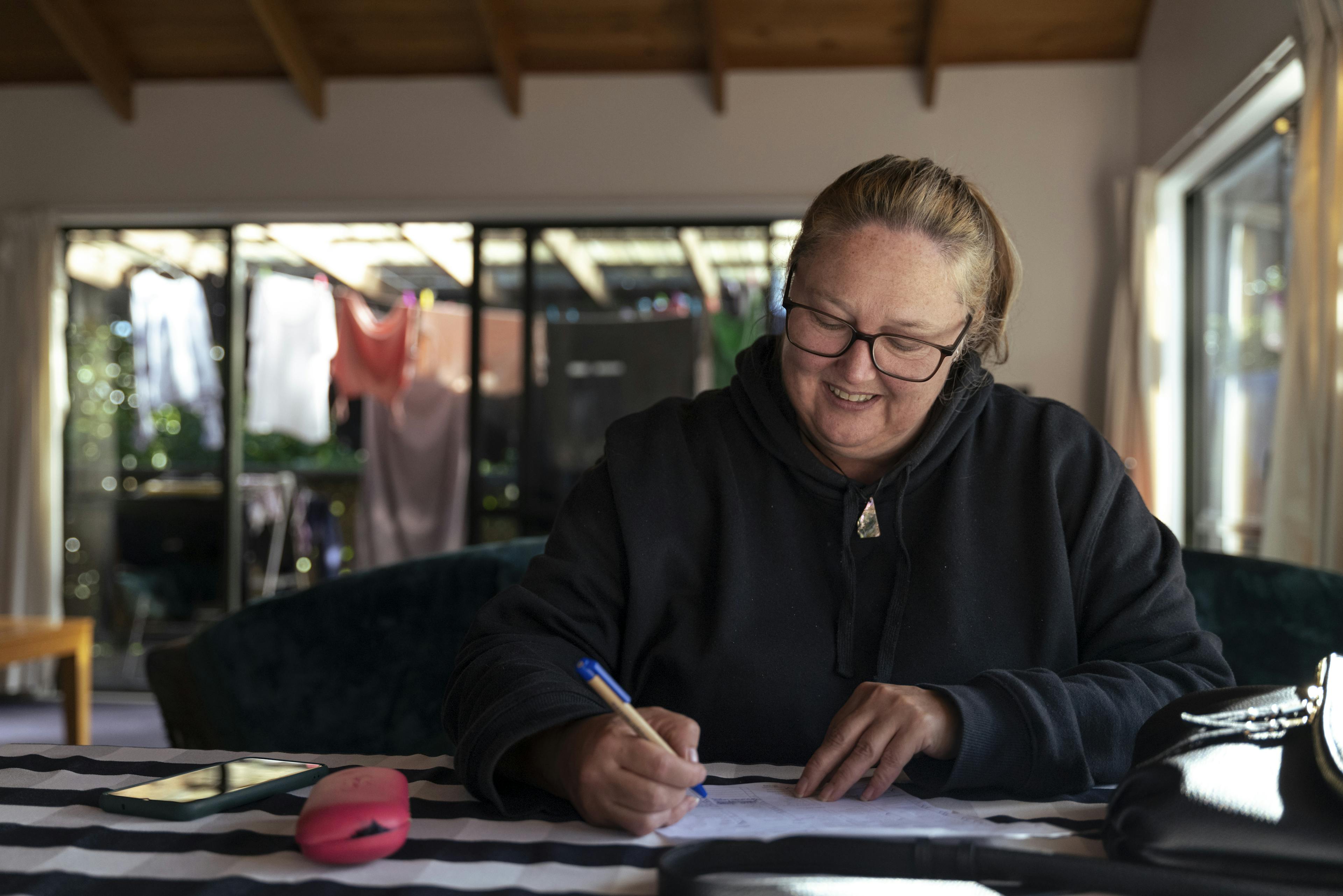 A Wings Trust community member in their residence applying techniques to have a normal everyday life