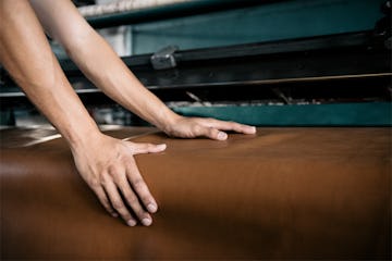Hands on unrolled leather