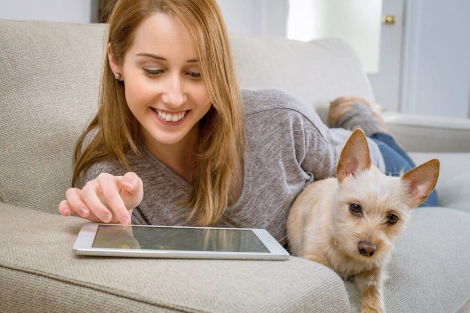 Woman reviewing DNA test results with dog