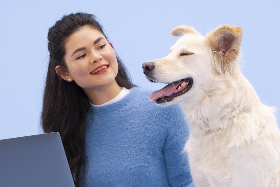 Woman reviewing dog DNA test results with her dog