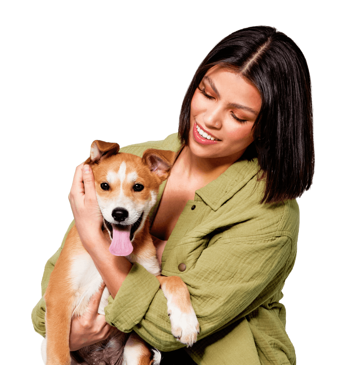Woman smiling and holding a cute red and white puppy
