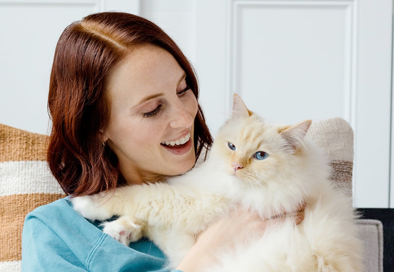 Woman snuggling a fluffy cat