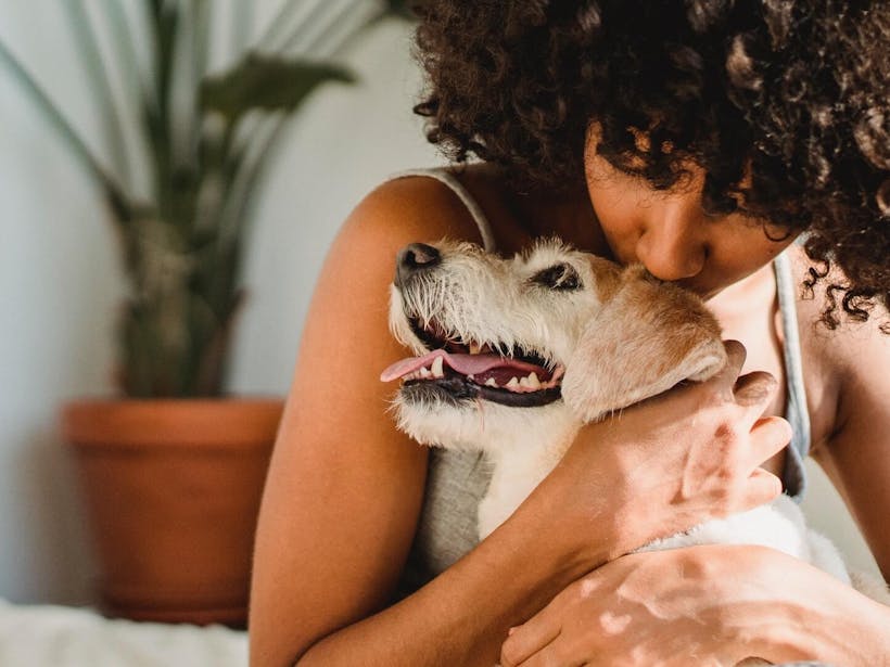 Woman hugging dog for emotional support