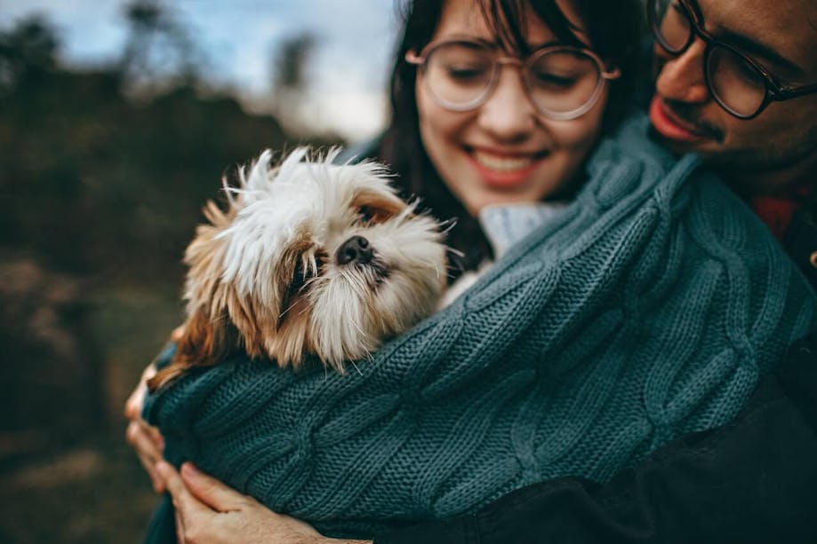 Young couple holding their dog