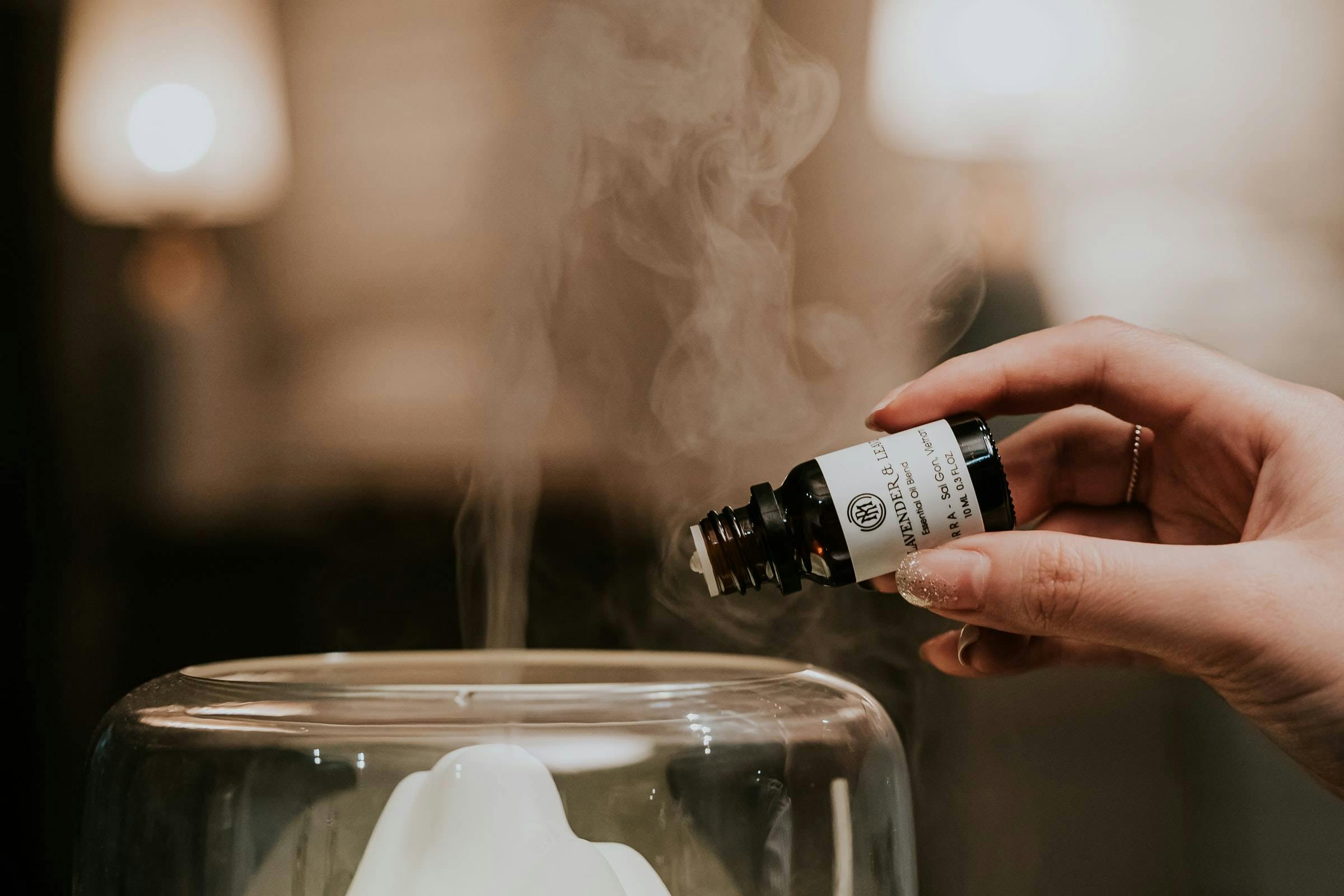 Essential oil being poured into diffuser