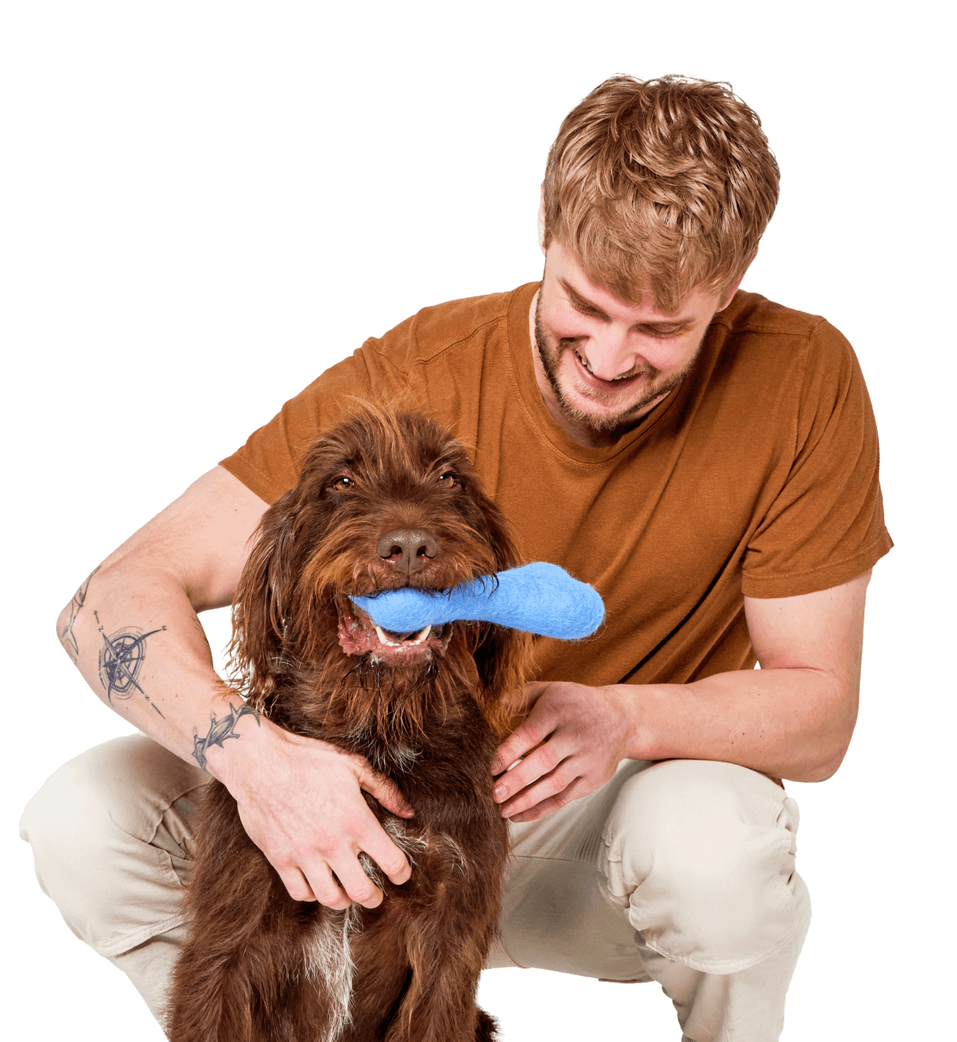 A man bending down to pet his brown, scruffy dog.
