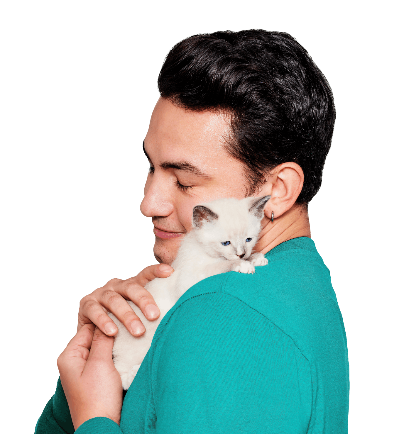 A man cuddling a small white kitten