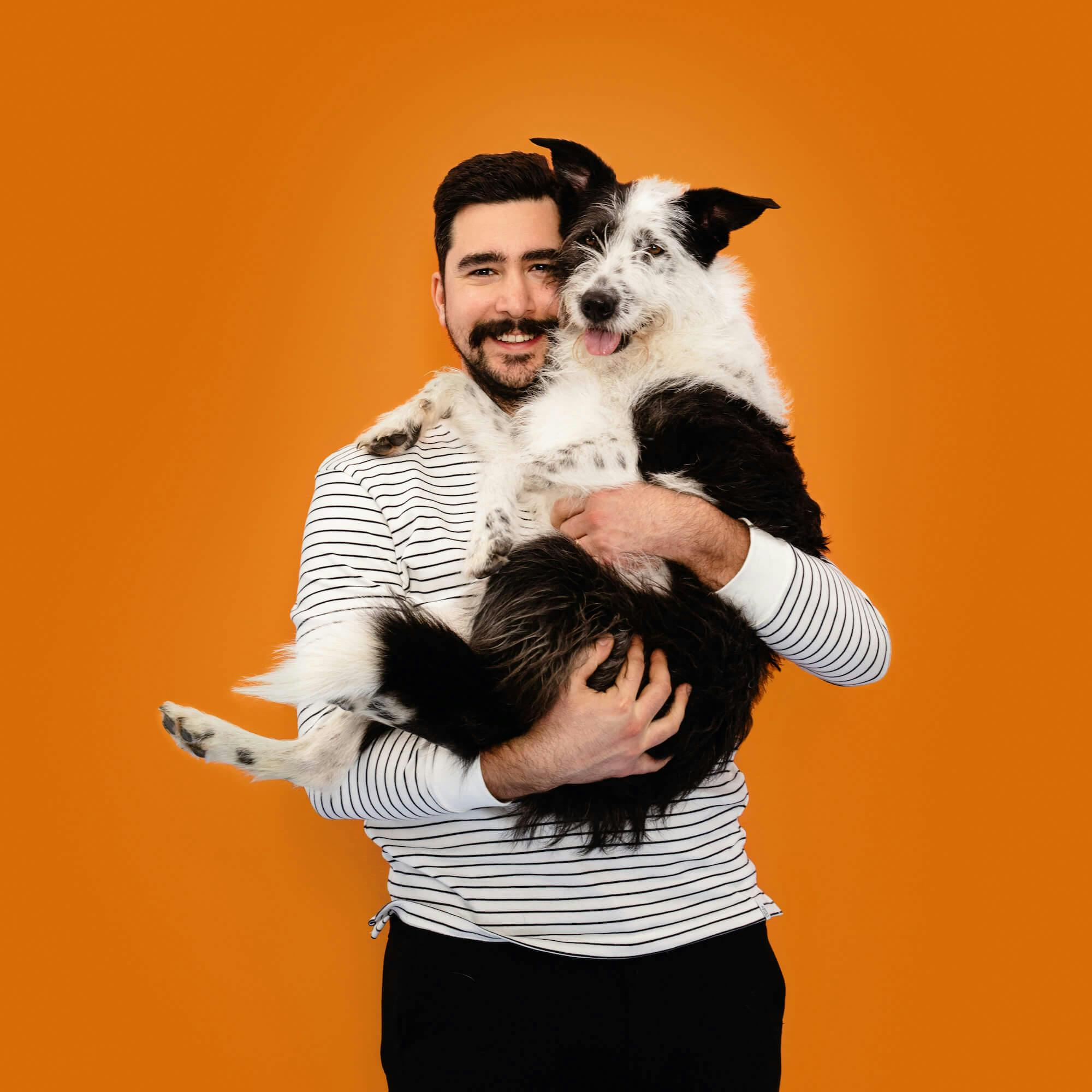 Smiling man holding a dog